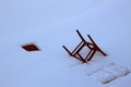 Old broken chair thrown in the snow Royalty Free Stock Photo