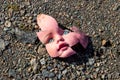 Old broken doll face on ground Royalty Free Stock Photo