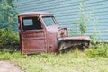 Old broken down abandoned rusted truck sits in a overgrown patch of weeds Royalty Free Stock Photo