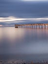 Old broken down wooden pier in Punta Arenas, old dock in Chile on the Pacific ocean. sunset Royalty Free Stock Photo