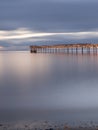 Old broken down wooden pier in Punta Arenas, old dock in Chile on the Pacific ocean. sunset Royalty Free Stock Photo