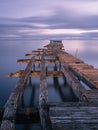 Old broken down wooden pier in Punta Arenas, old dock in Chile on the Pacific ocean Royalty Free Stock Photo