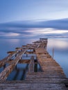 Old broken down wooden pier in Punta Arenas, old dock in Chile on the Pacific ocean Royalty Free Stock Photo