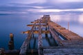 Old broken down wooden pier in Punta Arenas, old dock in Chile o Royalty Free Stock Photo