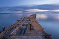 Old broken down wooden pier in Punta Arenas, old dock in Chile o Royalty Free Stock Photo