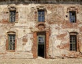 Old broken facade of the large house with wooden frame windows Royalty Free Stock Photo