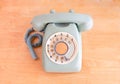 Green rotary phone on wooden table