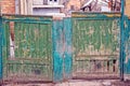Old broken green wooden gate in the street Royalty Free Stock Photo