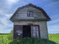 old and broken house made of white bricks on a blue sky background Royalty Free Stock Photo