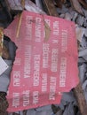 Old broken information plate in a pile of garbage with the inscription for combat cadets