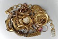 Old and broken jewelry, watches of gold, and gold-plated, and coins lie in a pile. A scrap of gold. Royalty Free Stock Photo