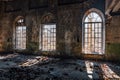 Old broken lancet windows inside abandoned building