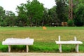 Old and broken long white cement bench for relaxing after the exercise beside the exercise yard Royalty Free Stock Photo