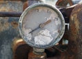 Old broken meter on an old rusty abandoned industrial engine Royalty Free Stock Photo