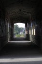 Old broken passage tunnel with light at the end, photographed with Wide-angle lens Royalty Free Stock Photo