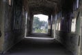 Old broken passage tunnel with light at the end, photographed with Wide-angle lens Royalty Free Stock Photo