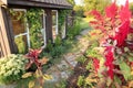 Old Broken Paver and Brick Path in Cottage Garden Flowers by Small Shed Royalty Free Stock Photo