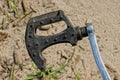 Old broken pedal of black plastic and gray metal on a bicycle Royalty Free Stock Photo