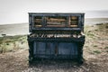 Old broken piano. Piano on beach