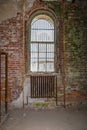 Old rusted radiator under a paladian window Royalty Free Stock Photo