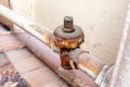 Old broken rusty heating valve on a rusty pipeline of heating battery need to be repared or replaced by the plumber Royalty Free Stock Photo