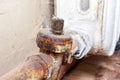 Old broken rusty heating valve on a rusty pipeline of heating battery need to be repared or replaced by the plumber Royalty Free Stock Photo