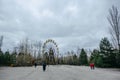 Abandoned carousel and abandoned ferris at an amusement park in the center of the city of Pripyat, the Chernobyl disaster, Royalty Free Stock Photo