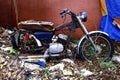 Old, broken and rusty motorcycle at an empty lot Royalty Free Stock Photo