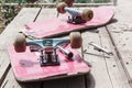 The old broken skateboard lies with a spanner on a wooden table in the open air Royalty Free Stock Photo