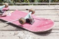 The old broken skateboard lies with a spanner on a wooden table in the open air