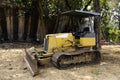 Old broken tractor machinery stop waiting thai technician people fix and repair on land construction site park garden of Wat