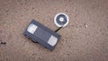 An old broken VHS videotape lies on asphalt Royalty Free Stock Photo