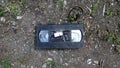 An old broken video cassette abandoned on the ground. Royalty Free Stock Photo