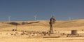 Old broken wind pump and new wind generators. Australia.