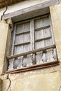 Old broken window of an abandoned house with wooden shutters Royalty Free Stock Photo