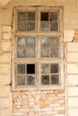 Old broken window with dust on a cracked brick wall Royalty Free Stock Photo