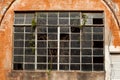 Old broken window glass on orange old brick wall Royalty Free Stock Photo