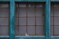 Old broken window with rusty iron lattices