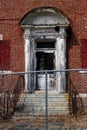 Old broken windows on abandoned brick asylum building Royalty Free Stock Photo