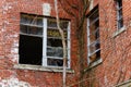 Old broken windows on abandoned brick asylum building Royalty Free Stock Photo