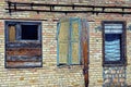 Old broken windows on the brick wall of an abandoned building