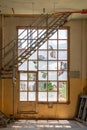 Old broken windows. with metal stairs inside a yellow building Royalty Free Stock Photo