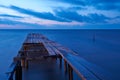 Old broken wooden bridge in the sea, long exposure, sunrise Royalty Free Stock Photo