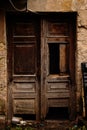 Old broken wooden brown door with empty bottles on the ground Royalty Free Stock Photo