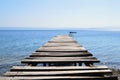 Old broken wooden pier in calm blue sea Royalty Free Stock Photo