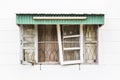 Old broken wooden windows on white concrete wall Royalty Free Stock Photo