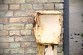 Old broken metal electricity box on brick wall Royalty Free Stock Photo