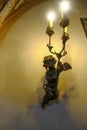 old bronze angel chandelier on the wall of the living room close-up. Interior design. Interior decor Royalty Free Stock Photo