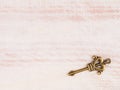 Old bronze antique key on light brown wooden background Royalty Free Stock Photo