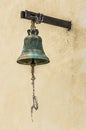 Old bronze bell on the wall with a rope Royalty Free Stock Photo